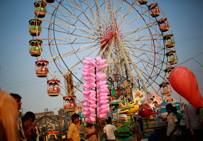 Top ten: Mumbai, India: A man waits for customers to sell candy floss at the Mahim f