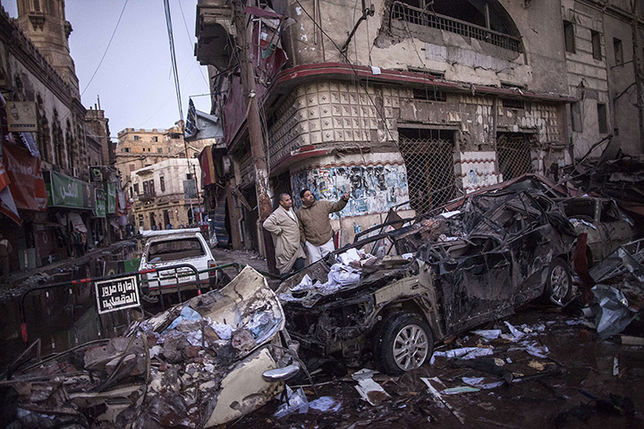 Top ten: Mansura, Egypt: Egyptian men inspect destruction following a powerful car b