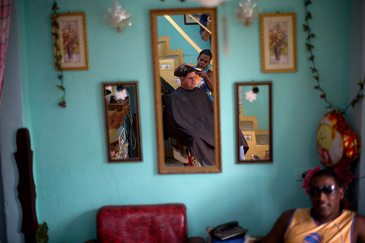 10 photo highlights: Customers have their hair cut at a private hair salon in Havana, Cuba