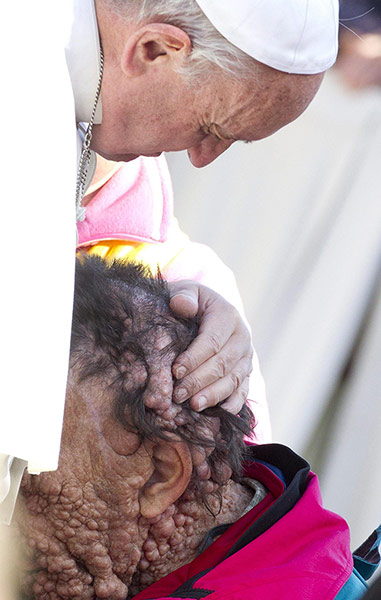 20 Photos: Pope Francis caresses a sick person in Saint Peter's Square at Vatican City