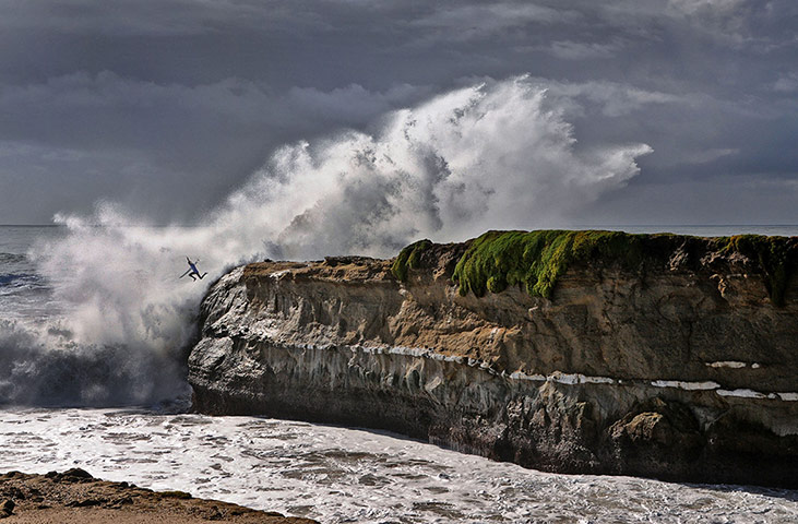 20 Photos: A surfer leaps into the sea from Lighthouse Point, Santa Cruz