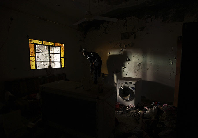 20 Photos: A Free Syrian Army fighter carries his weapon in a house in Deir e-Zor