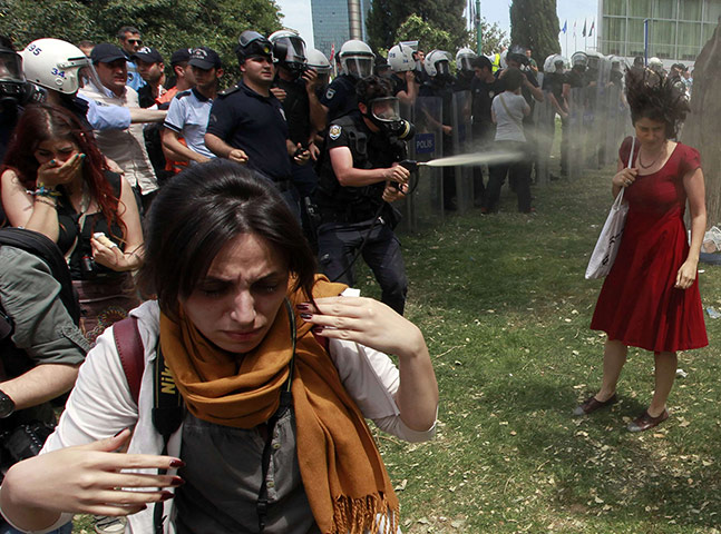 20 Photos: A Turkish riot policeman uses teargas in Taksim Square, Istanbul