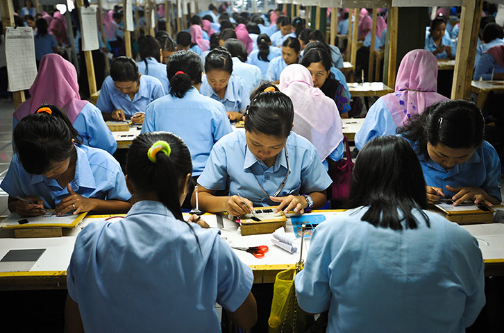 Eyelashes: Women knitting false eyelashes at a satellite workshop 