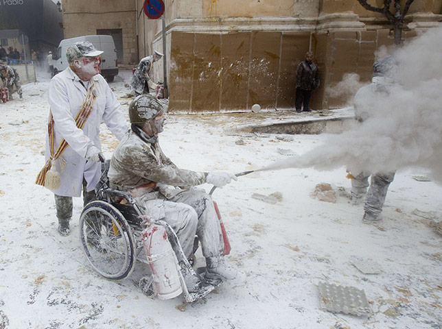 Flour festival: Revelers, dressed in mock military dress