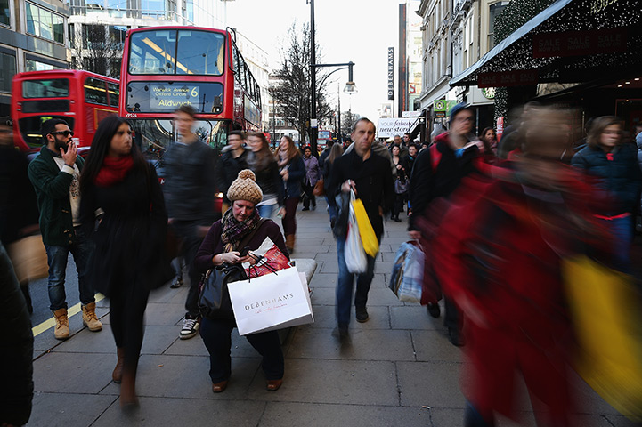 the weekend in pictures: A woman takes a break from shopping on Oxford Street