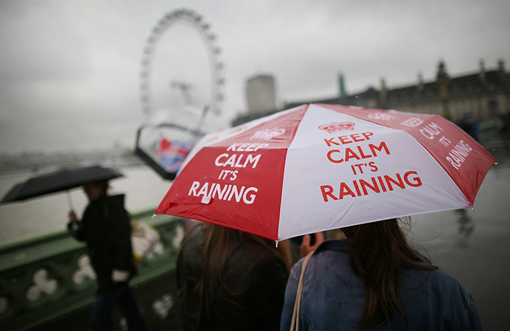 the year in weather: Pedestrians walk over Westminster Bridge in heavy rain
