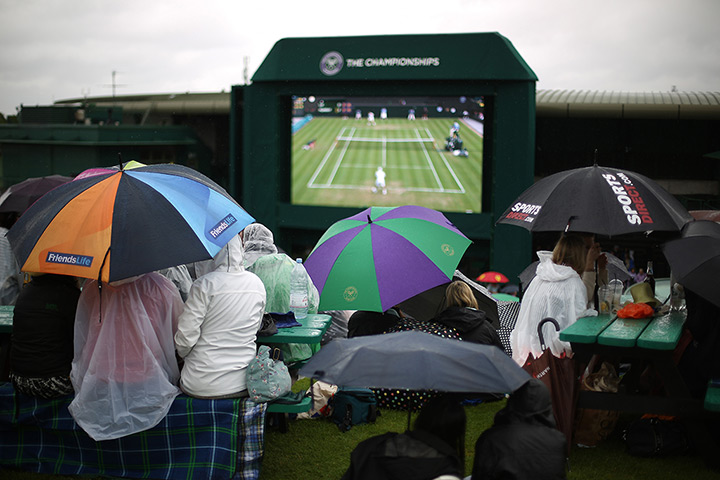 the year in weather: Spectators watch a replay of highlights at Wimbledon