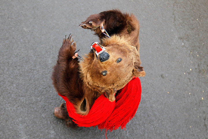 Photo highlights : A dancer from Moldova performs the bear dance, a ritual for good luck in the New Year