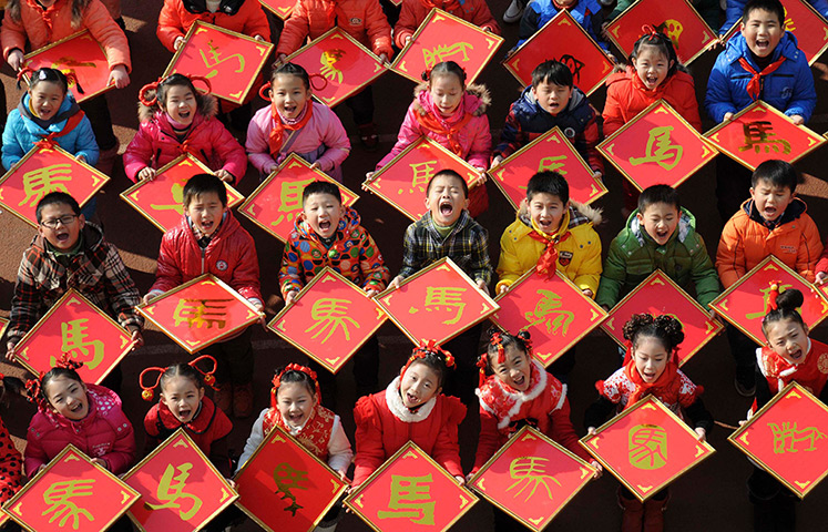 Photo highlights: Jiujiang, China: Children pose for pictures with the Chinese character 