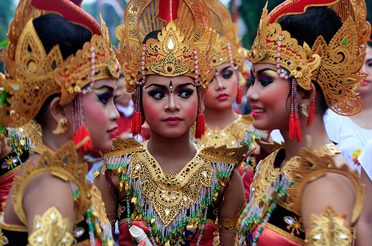 Photo highlights: Bali, Indonesia: Girls in traditional costumes gather during a New Year's E