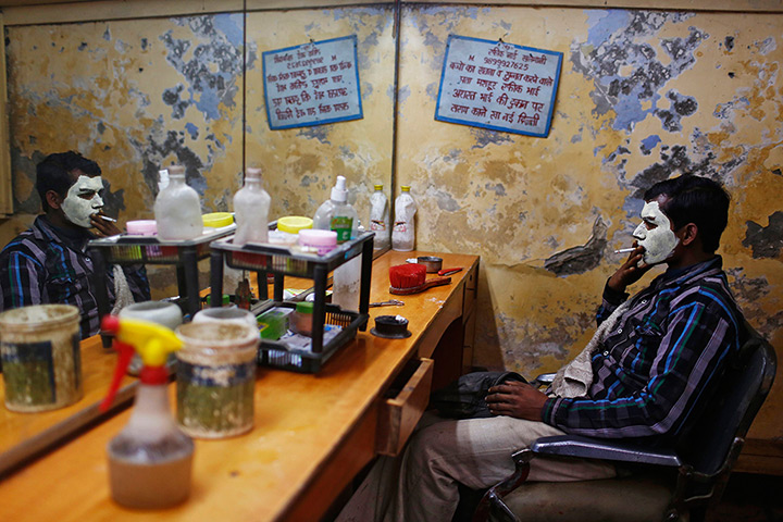 Photo highlights: New Delhi, India: A migrant labourer with his face covered with facial crea