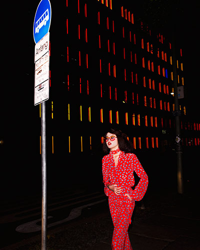 Fashion - Neon nights: Model dressed in red outfit photographed at night