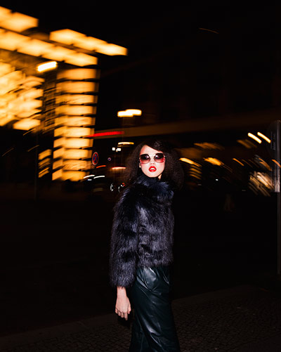 Fashion - Neon nights: Model at night wearing black outfit 