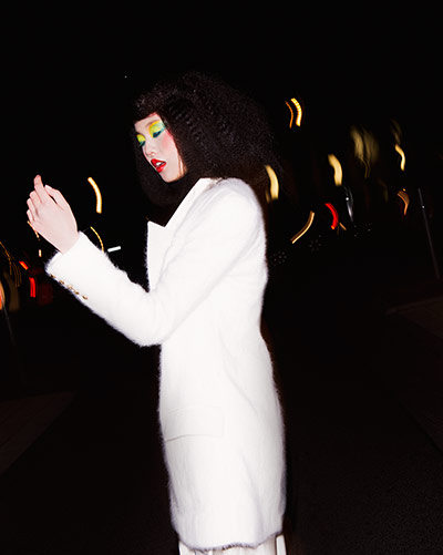 Fashion - Neon Nights: model dressed in white coat