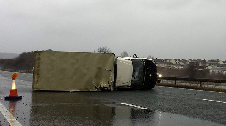 Weather : An overturned lorry on the M6 as strong winds batter the UK