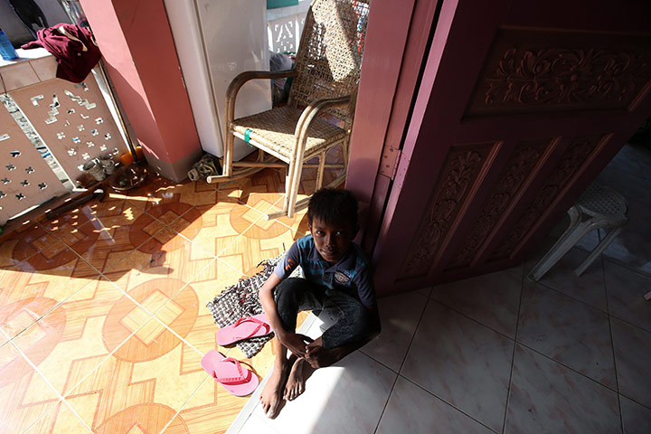 Joshua Cator: Joshua sits inside a damaged house