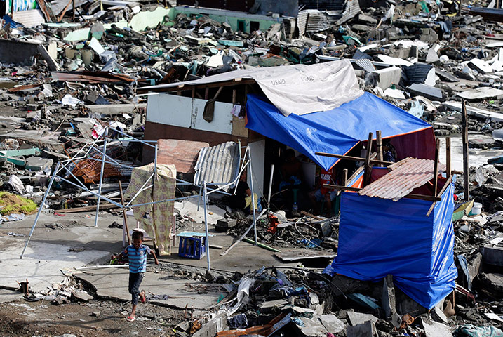 Joshua Cator: Joshua Cator runs outside a makeshift house