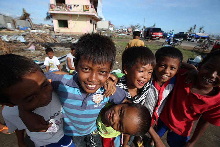 Joshua Cator: Joshua smiles with his friends while waiting for relief goods distribution