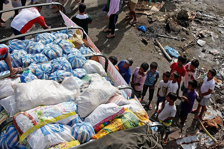 Joshua Cator: Joshua stands with friends while waiting for relief goods