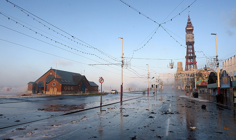 Weather update: Debris from the sea is strewn across the road after a high tide in Blackpoo