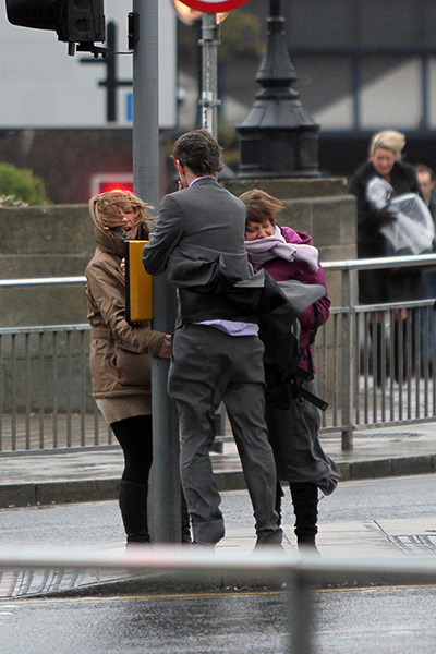 Weather update: Commuters hold on to lamp post in strong winds , Bridgewater Place in Leeds