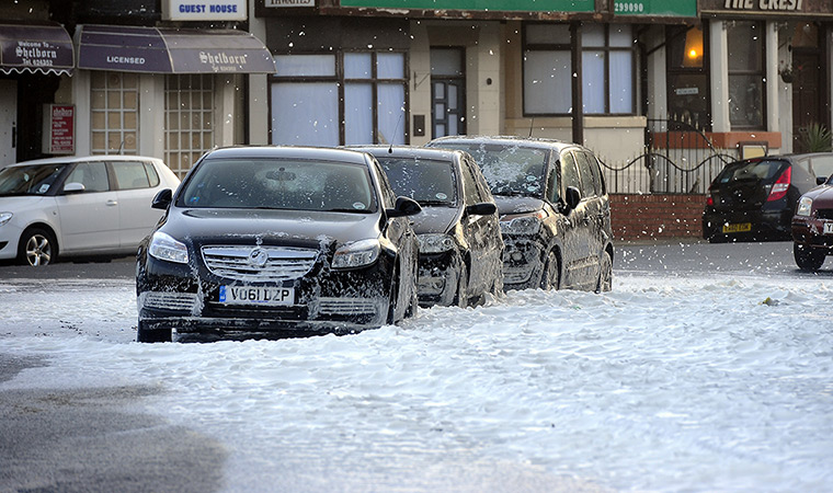 UK weather: Streets in Blackpool fill with white foam driven in from the sea