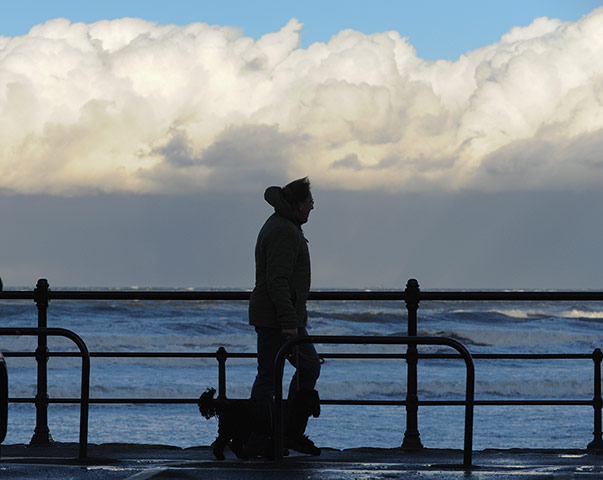 Weather gallery update: A man walks his dog along the lower promenade in Saltburn