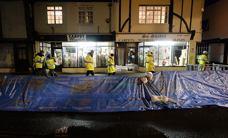 Weather UK: A make-shift flood barrier runs along the high street of Sandwich in Kent,