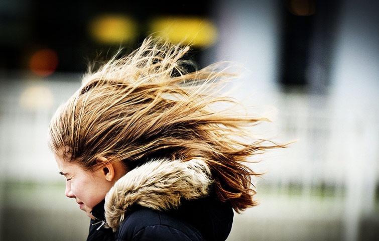 Storm Xaver in Europe: A girl struggles against the wind in Rotterdam