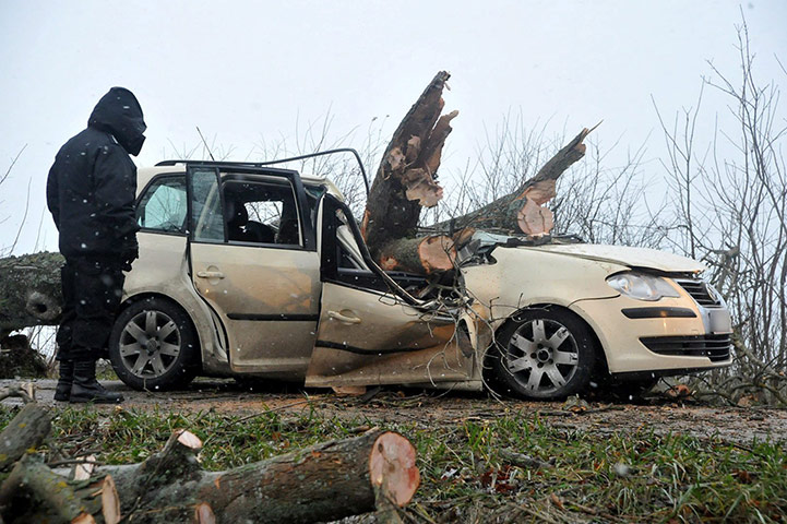 Storm Xaver update: A police officer surveys the site of a traffic accident in Pomerania, northern Poland