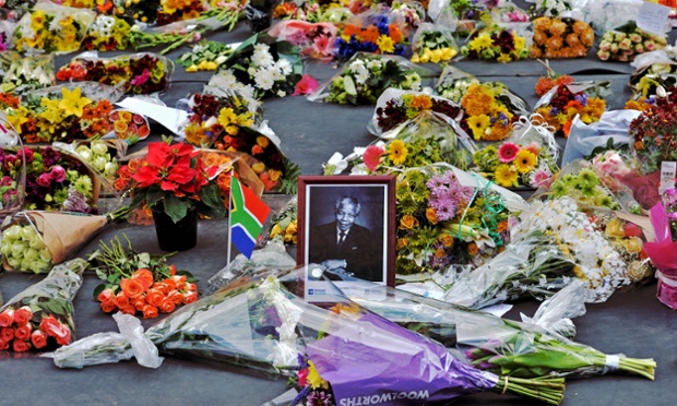 Flowers left by mourners surround a portrait of Mandela in the Sandton district of Johannesburg.