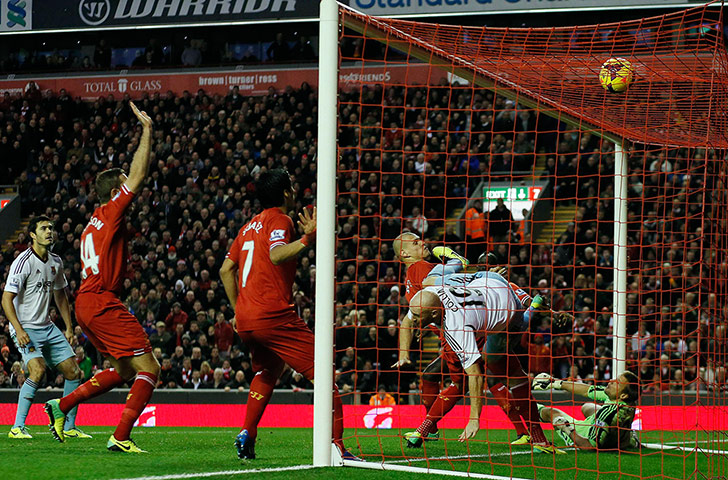 Prem Roundup: Liverpool's Jordan Henderson Luis Suarez and Martin Skrtel watch as the bal