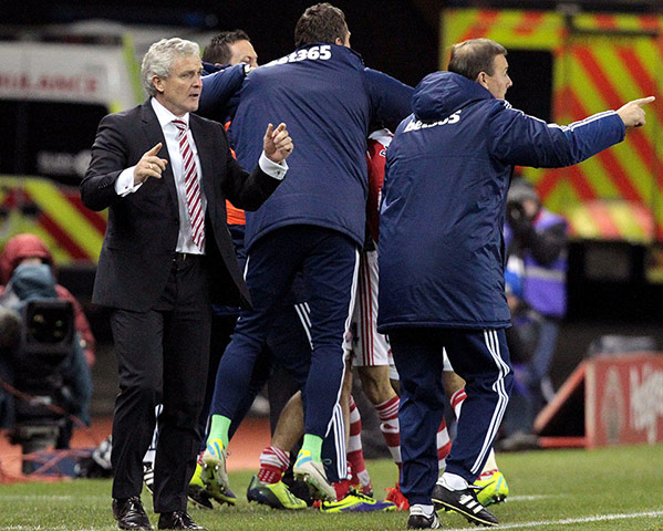 Prem Roundup: Stoke City's Welsh manager Mark Hughes celebrates his team's late goal to w