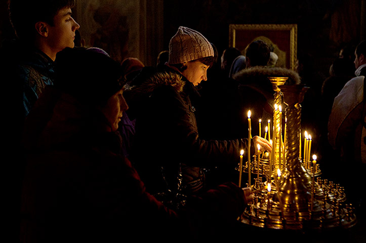 Ukrainian protests woman lights candles at the Mikhailovsky Cathedral 