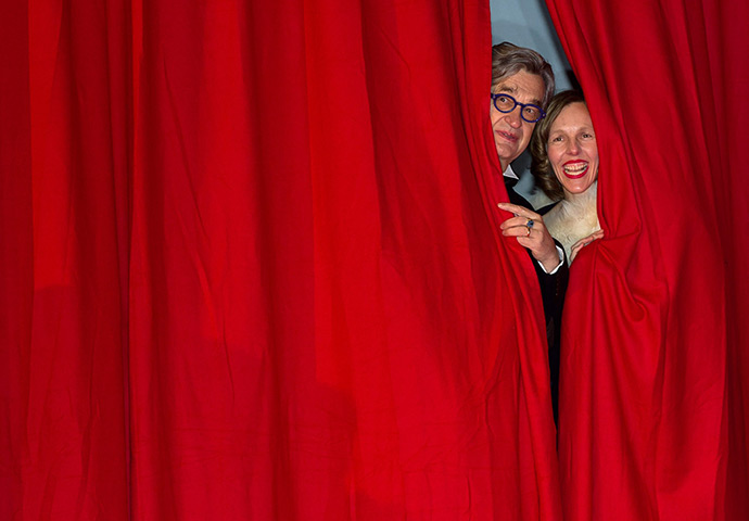 Weekend in pictures: Berlin, Germany: Wim Wenders and his wife Donata look out from behind a red