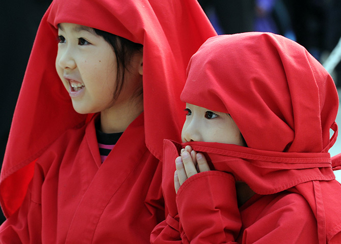 Weekend in pictures: Iga, Japan: Girls wearing ninja costumes watch a performance during the Iga