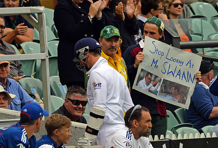 sport: England's Graeme Swann (C) walks back to
