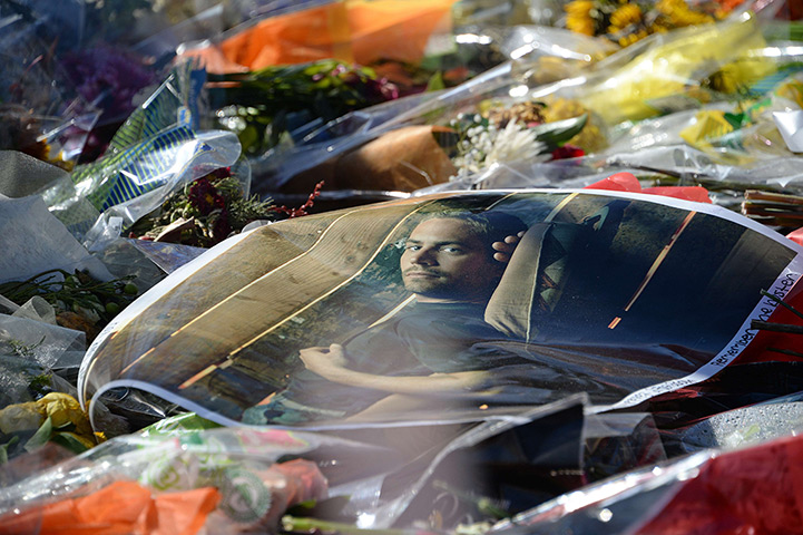 Paul Walker memorial: A poster of actor Paul Walker lies on top of flowers and other mementos lef