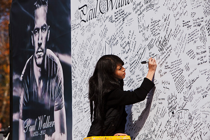 Paul Walker memorial: A fan signs a memorial board