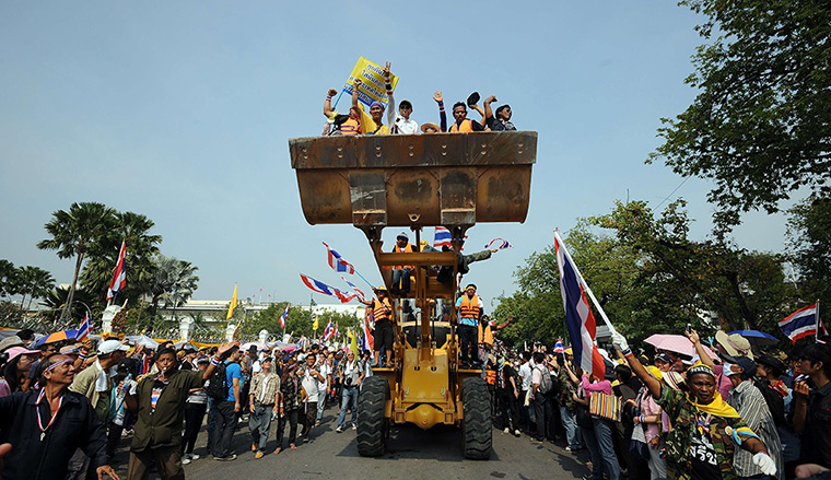 Thai protests: Anti-government protesters celebrate after removing concrete barricades out