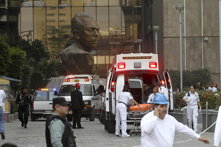 Mexico explosion: Paramedics treat injured people in ambulances outside the building