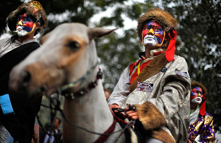 24 hours in pictures: An exiled Tibetan in traditional attire rides a horse