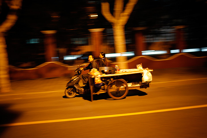 24 hours in pictures: Couple drive their motorcycle pulling a food car