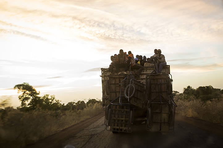 24 hours in pictures: Malian people travel on top of a truck