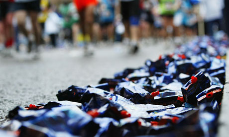 Are they good for you? Runners pass discarded drink containers during a marathon.