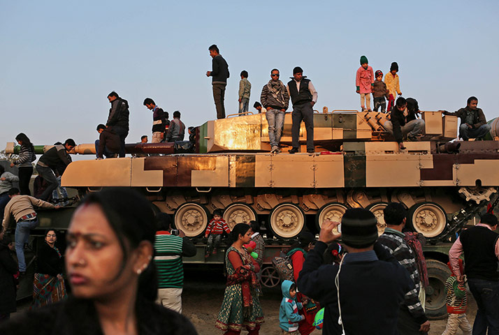 20 Photos: People gather on top of an Indian Army armored tank in New India
