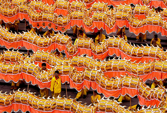 24 hours in pictures: erformers with a 238 metre long golden dragon