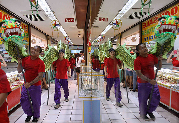 Chinese New Year: Dancers are reflected in a mirror 