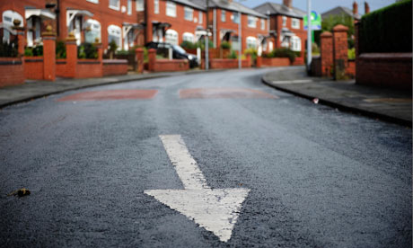 Houses in Greater Manchester and arrow on the road